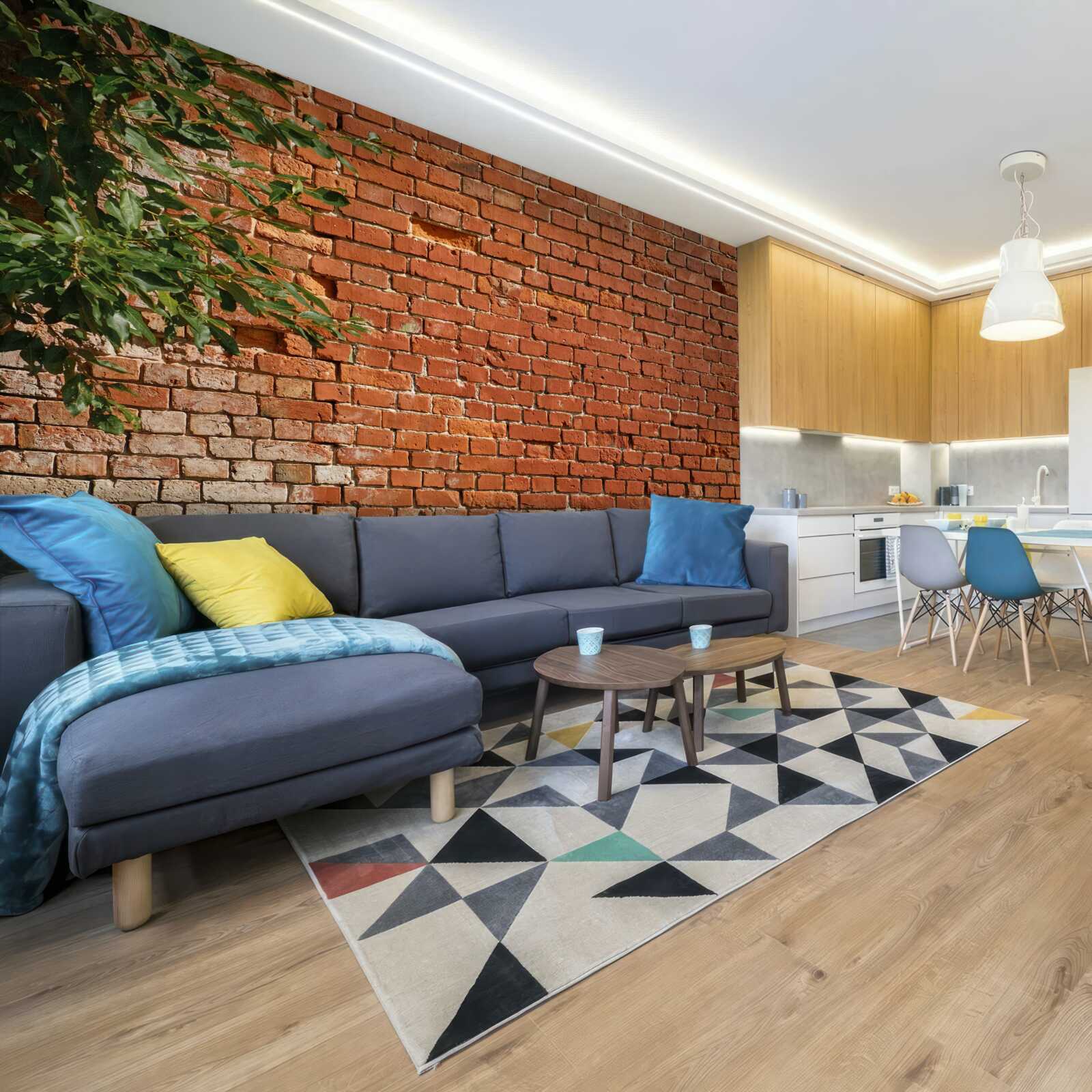 Fototapet o creangă de lemn lângă o barieră de cărămidă