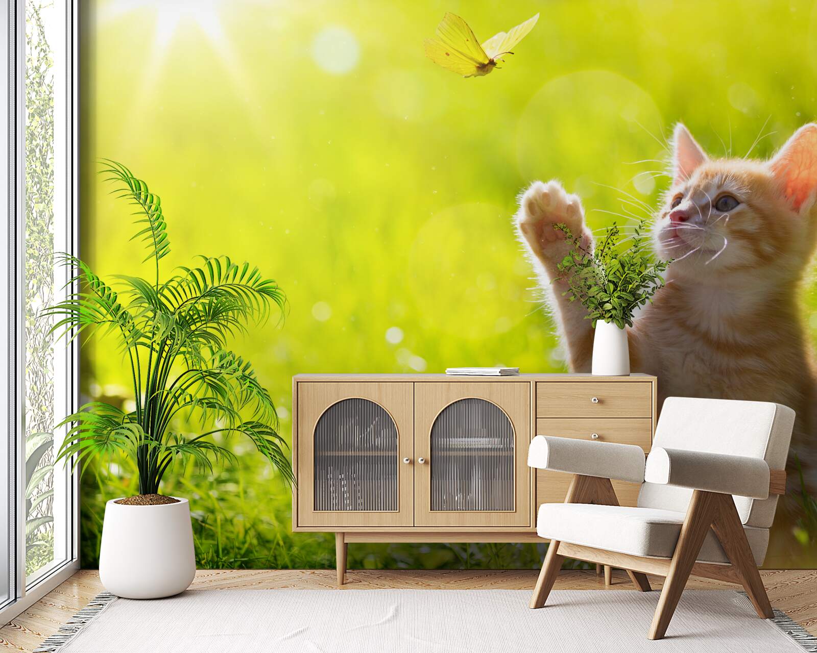 Fototapet o pisică mică se joacă cu un fluture pe un câmp verde