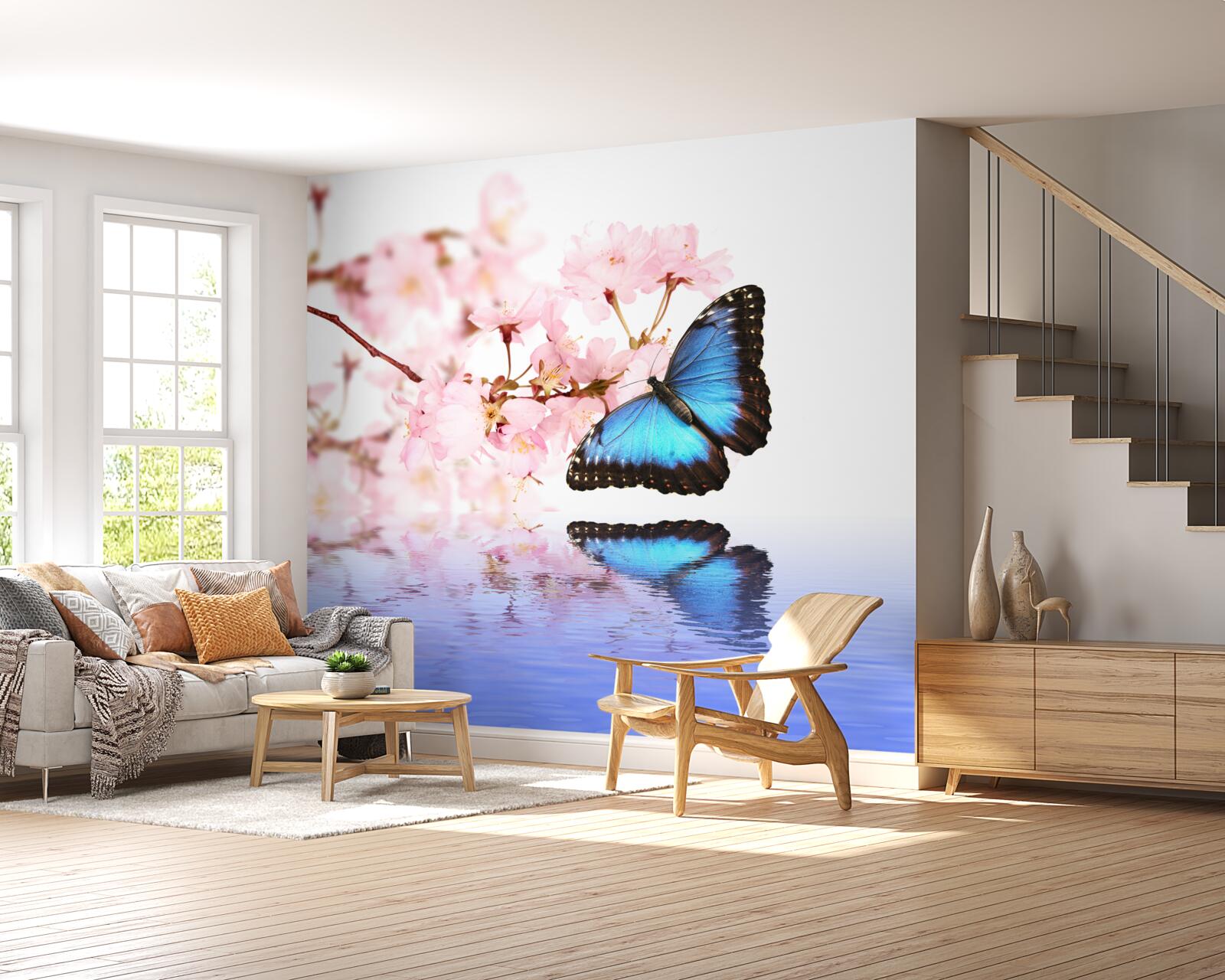 Fototapet un fluture albastru stă pe un cireș lângă apă